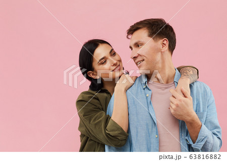 Smiling Couple Posing on Pink Smiling Couple Posing on Pink 63816882