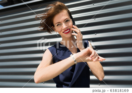 Female in office suit made an appointment and call the phone outside Female in office suit made an appointment and call the phone outside 63818169