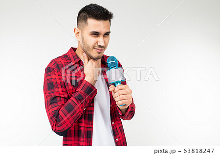 guy sings in karaoke holding a microphone in his hand on a white background 63818247