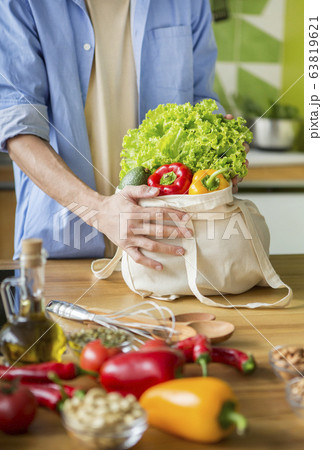 Man vegetarian buying vegetables and want to prepare dinner Man vegetarian buying vegetables and want to prepare dinner 63819621