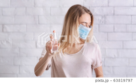 Distance from virus concept. Girl with medical mask and antiseptics 63819797