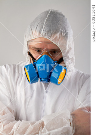 Scared man wearing protective clothing and respiratory mask. 63821641