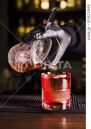 Preparing red cocktail on the bar in a beautiful 63821848