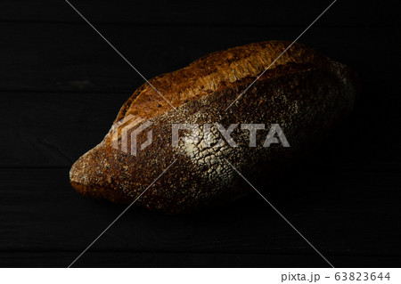 French bread on a black wooden table 63823644