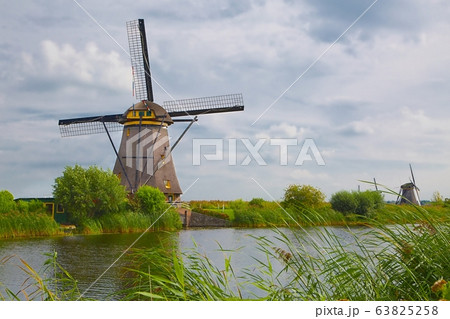 Windmill beside a canal 63825258