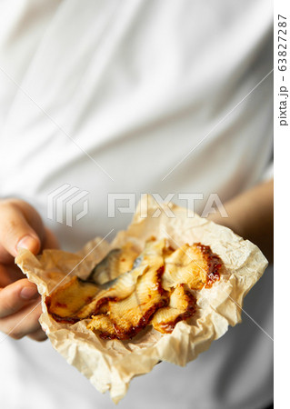 chef holding smoked eel slices in his hands. eel slices in chef hands. chef holding smoked eel slices in his hands. eel slices in chef hands. 63827287