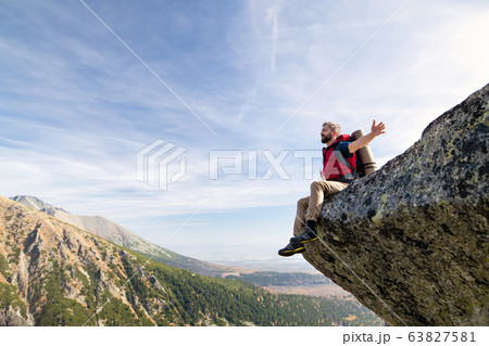 Mature man with backpack hiking in mountains in autumn, resting. Mature man with backpack hiking in mountains in autumn, resting. 63827581