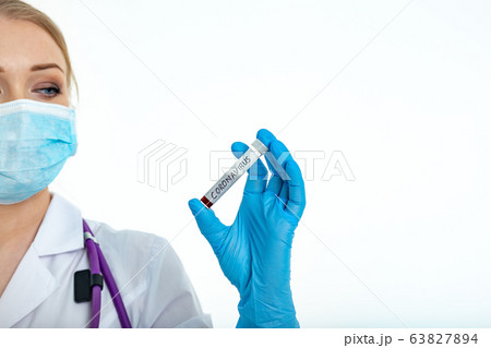 A nurse s hand in a glove holds a test tube with A nurse s hand in a glove holds a test tube with 63827894
