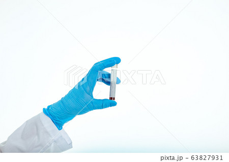 Doctor's hand in a medical glove holds a test tube 63827931