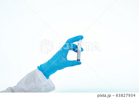 Doctor's hand in a medical glove holds a test tube 63827934