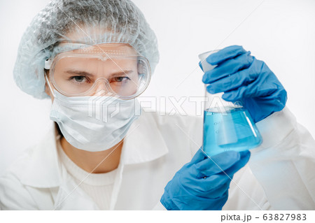 concentrated doctor in protective mask holding flask to make coronavirus test concentrated doctor in protective mask holding flask to make coronavirus test 63827983