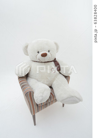 White teddy bear in chair. Isolated on white background 63828400