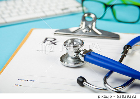 keyboard and Medical stethoscope lying on cardiogram chart closeup. Medical help, prophylaxis, disease prevention or insurance concept. Cardiology care. 63829232