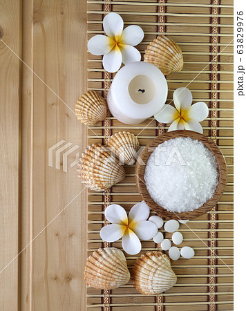 Shells and tiare flowers on the wooden background Shells and tiare flowers on the wooden background 63829976