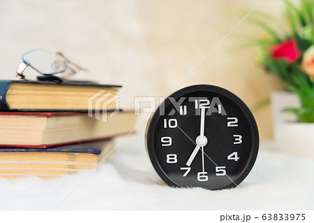 Black alarm clock on table 63833975