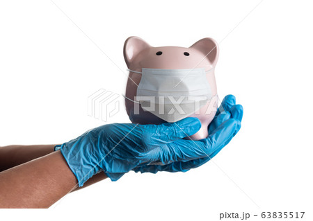 Doctor or Nurse Wearing Surgical Gloves Holding Piggybank Doctor or Nurse Wearing Surgical Gloves Holding Piggybank 63835517