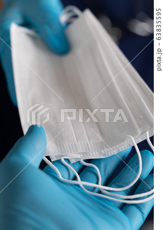 Doctors or Nurses Wearing Surgical Gloves Handing PPE Protective Face Mask 63835595