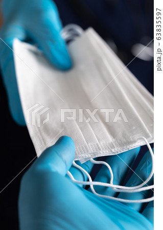 Doctors or Nurses Wearing Surgical Gloves Handing PPE Protective Face Mask 63835597