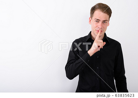Young handsome businessman against white background Young handsome businessman against white background 63835623