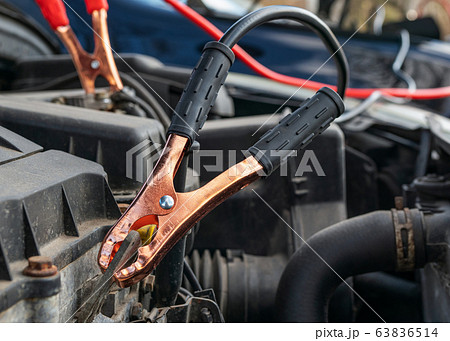 Jump cables on car battery Jump cables on car battery 63836514