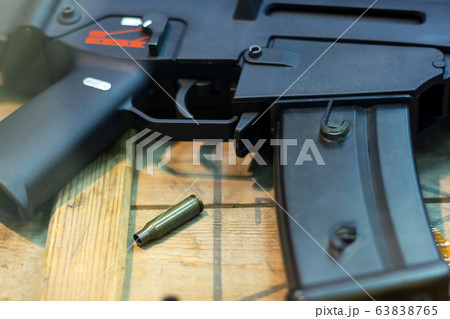 Cartridges Pistol. The gun is next to the cartridges. Weapon Suitcase for the gun. Buying weapons. Cartridges of different calibers next to the gun. Weapons storage. Collectible 63838765