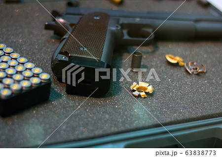Cartridges Pistol. The gun is next to the cartridges. Weapon Suitcase for the gun. Buying weapons. Cartridges of different calibers next to the gun. Weapons storage. Collectible Cartridges Pistol. The gun is next to the cartridges. Weapon Suitcase for the gun. Buying weapons. Cartridges of different calibers next to the gun. Weapons storage. Collectible 63838773