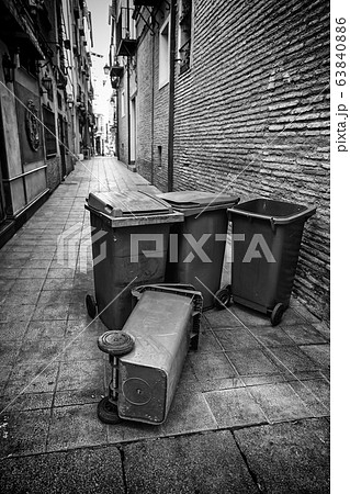 Garbage containers lying in the street 63840886
