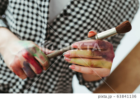 Hands of artist holding artistic brush for watercolors 63841136
