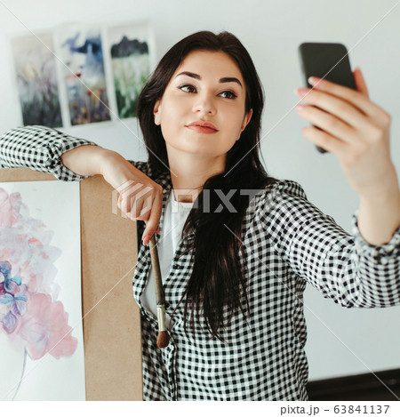 Young artist taking selfie with watercolor artwork Young artist taking selfie with watercolor artwork 63841137