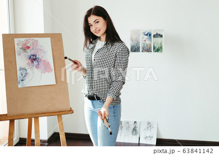Woman do easel painting with watercolors Woman do easel painting with watercolors 63841142
