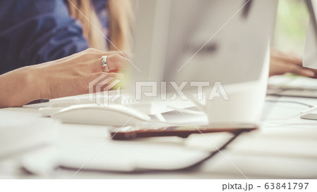 Businesswoman hand typing on computer at desk. 63841797