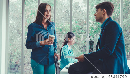 Businesswoman and businessman having conversation. Businesswoman and businessman having conversation. 63841799