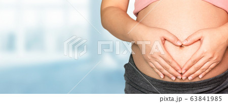 Pregnant woman at hospital health check up. Pregnant woman at hospital health check up. 63841985