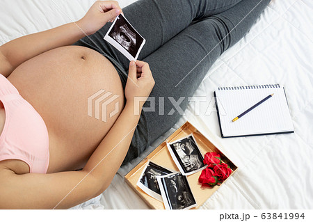 Happy pregnant woman and expecting baby at home. Happy pregnant woman and expecting baby at home. 63841994