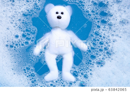 Soaking bear toy in laundry detergent water Soaking bear toy in laundry detergent water 63842065