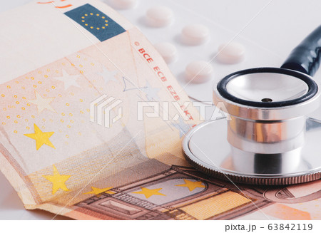 Close-Up Of Stethoscope On Paper Currencies. Close-Up Of Stethoscope On Paper Currencies. 63842119
