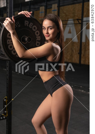 Young woman training in a gym view Young woman training in a gym view 63842970