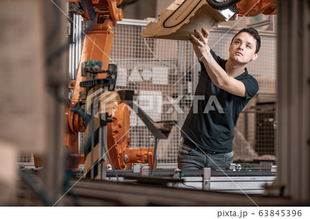 installation of new robot arms in the factory for modernization of production installation of new robot arms in the factory for modernization of production 63845396