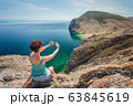 Girl makes a photo of Baikal 63845619