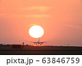 離陸する飛行機と夕日　熊本空港 63846759