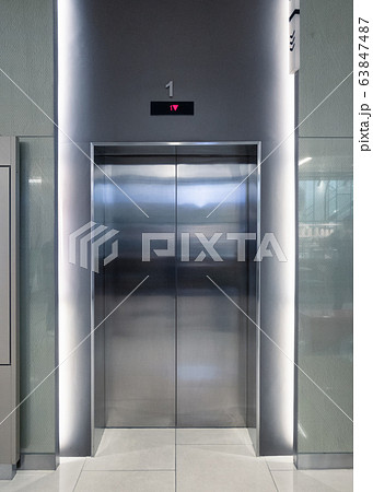 Closed elevator doors glossy illuminated in hotel Closed elevator doors glossy illuminated in hotel 63847487