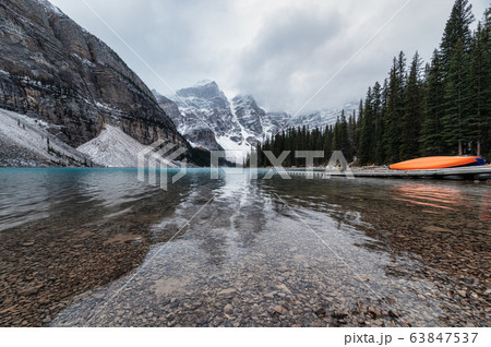 Rocky mountains with canoe on pier in Moraine Lake 63847537