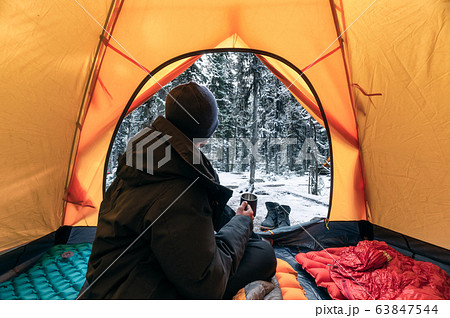 Man traveler wearing winter coat with sitting and Man traveler wearing winter coat with sitting and 63847544