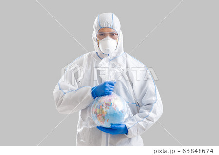 Male disinfector in protective suit holds globe 63848674
