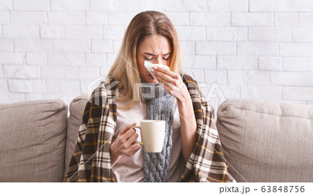 Girl with tea treated at home during coronavirus Girl with tea treated at home during coronavirus 63848756