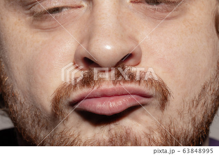 Close-up male mouth illustrating emotions. Cosmetology, dentistry and beauty care, facial expression 63848995