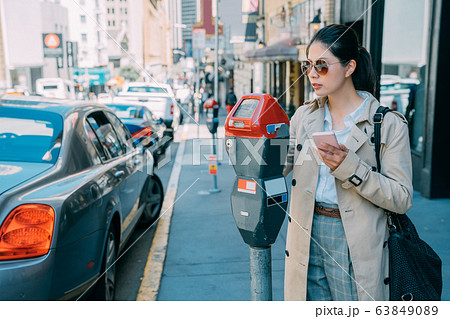 Young charming asian Japanese woman paying for car Young charming asian Japanese woman paying for car 63849089