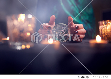 Close-up of fortuneteller woman's hands with predictions ball Close-up of fortuneteller woman's hands with predictions ball 63849378