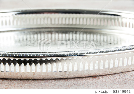 Antique silver plated tray on concrete background. Antique silver plated tray on concrete background. 63849941