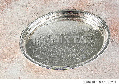 Antique silver plated tray on concrete background. Antique silver plated tray on concrete background. 63849944